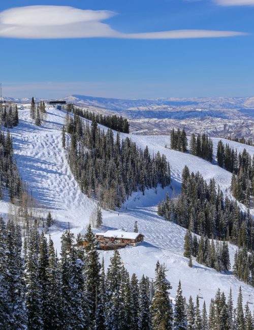 Alpine downhill ski runs on a blue sky day in winter in Aspen, Colorado